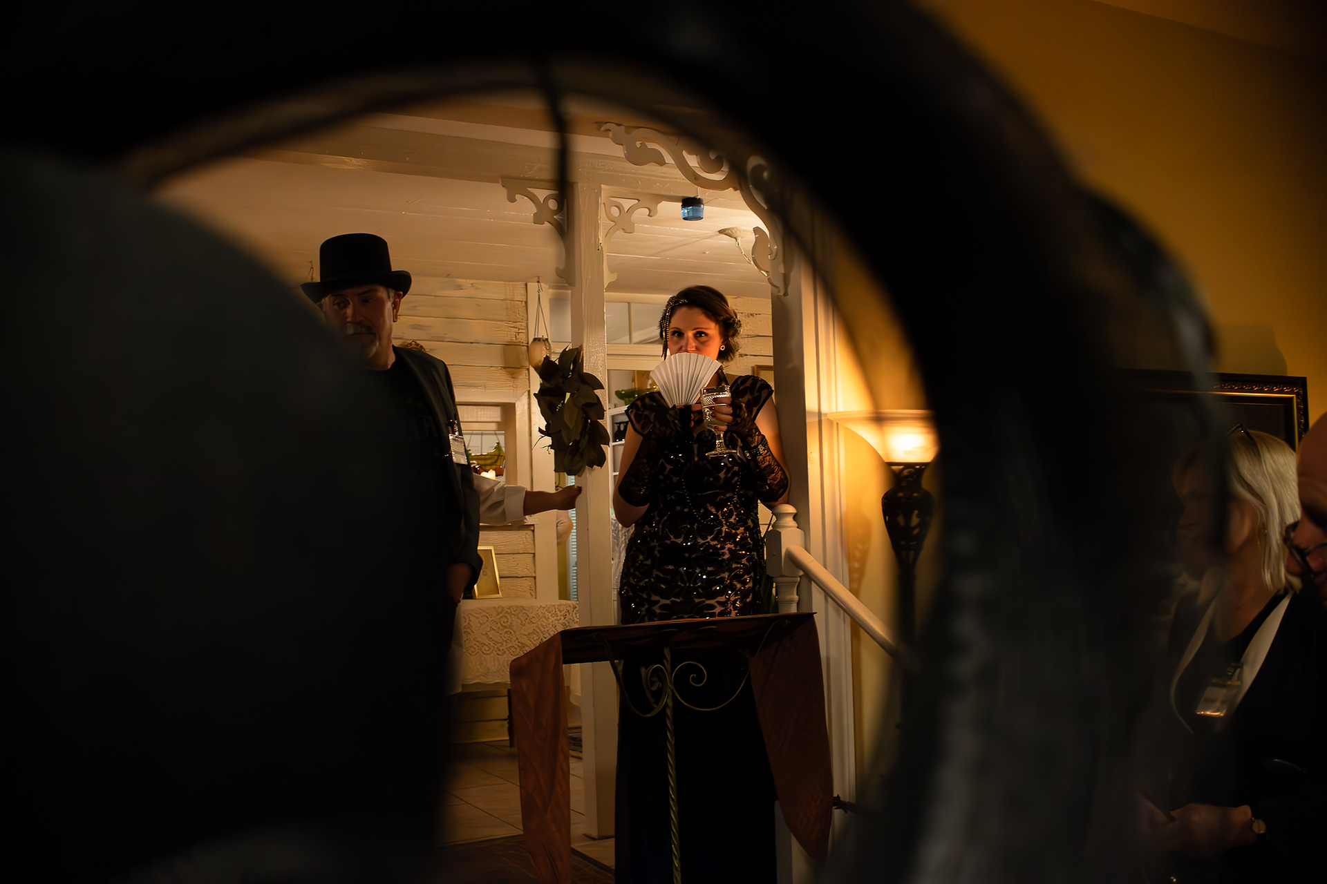 creative photo taken through a costume hat at murder mystery dinner
