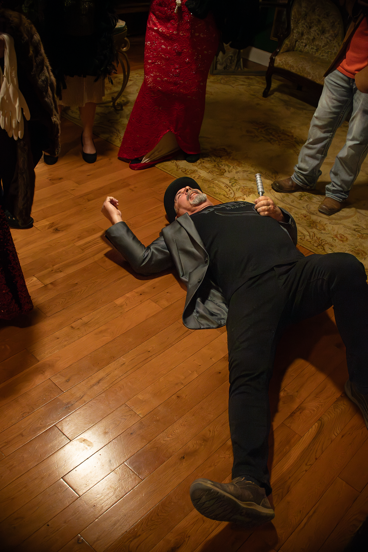 photo of guest on floor after being "stabbed" during murder mystery dinner at Whistlestop Manor