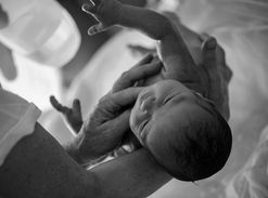 newborn baby being held