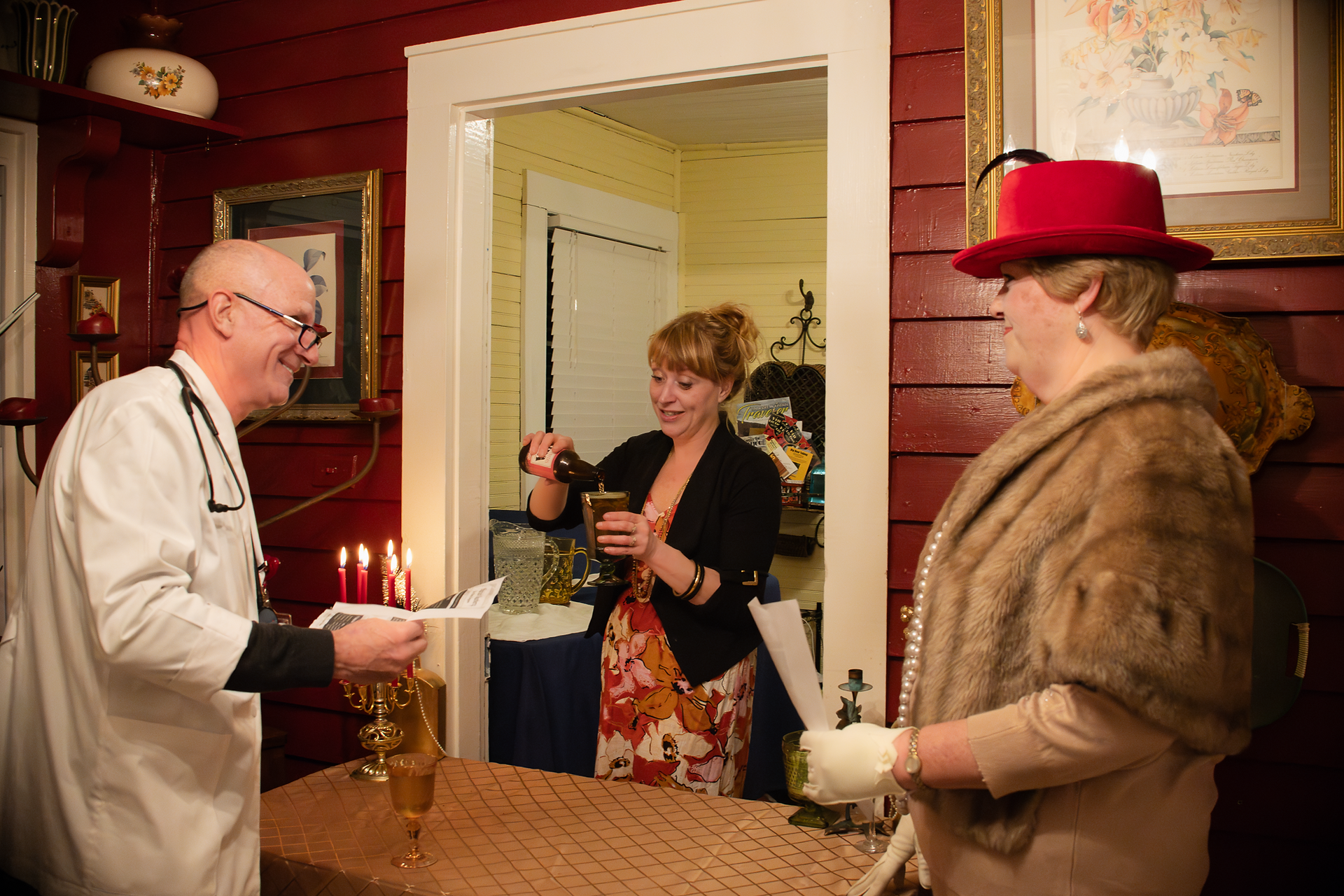 candid branding photo of Whistlestop ownerm pouring a drink for guests at murder mystery dinner party