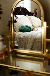 vanity reflection of bundled newborn laying on bed, in-home session near Chattanooga, Tennessee