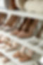Different stylish women's shoes on shelving unit.jpg