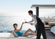 Waiter Serving Wine with Ocean View