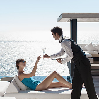 Waiter Serving Wine with Ocean View