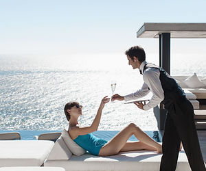 Waiter Serving Wine with Ocean View