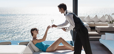 Waiter Serving Wine with Ocean View