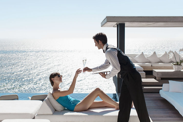 Waiter Serving Wine with Ocean View