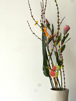 Three ikebana arrangements showing radiating, parallel, and crossing patterns with flowers and branches in vases demonstrating free style Japanese flower design techniques