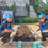 Thumbnail: Two female volunteers smiling while preparing garden beds during a community CSR activity in Bangkok.
