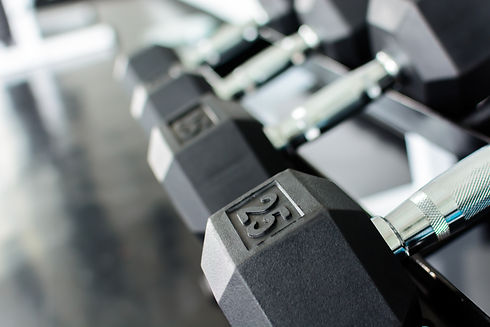 Close up rows of dumbbells on a rack in a gym.jpg
