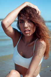 Confident woman walking along a promenade in a casual outfit