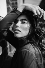 Monochrome image of a relaxed woman posing with a tilted head