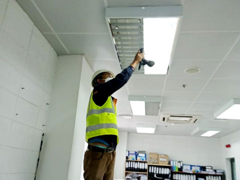 Maintenance worker making small fixes on construction site.