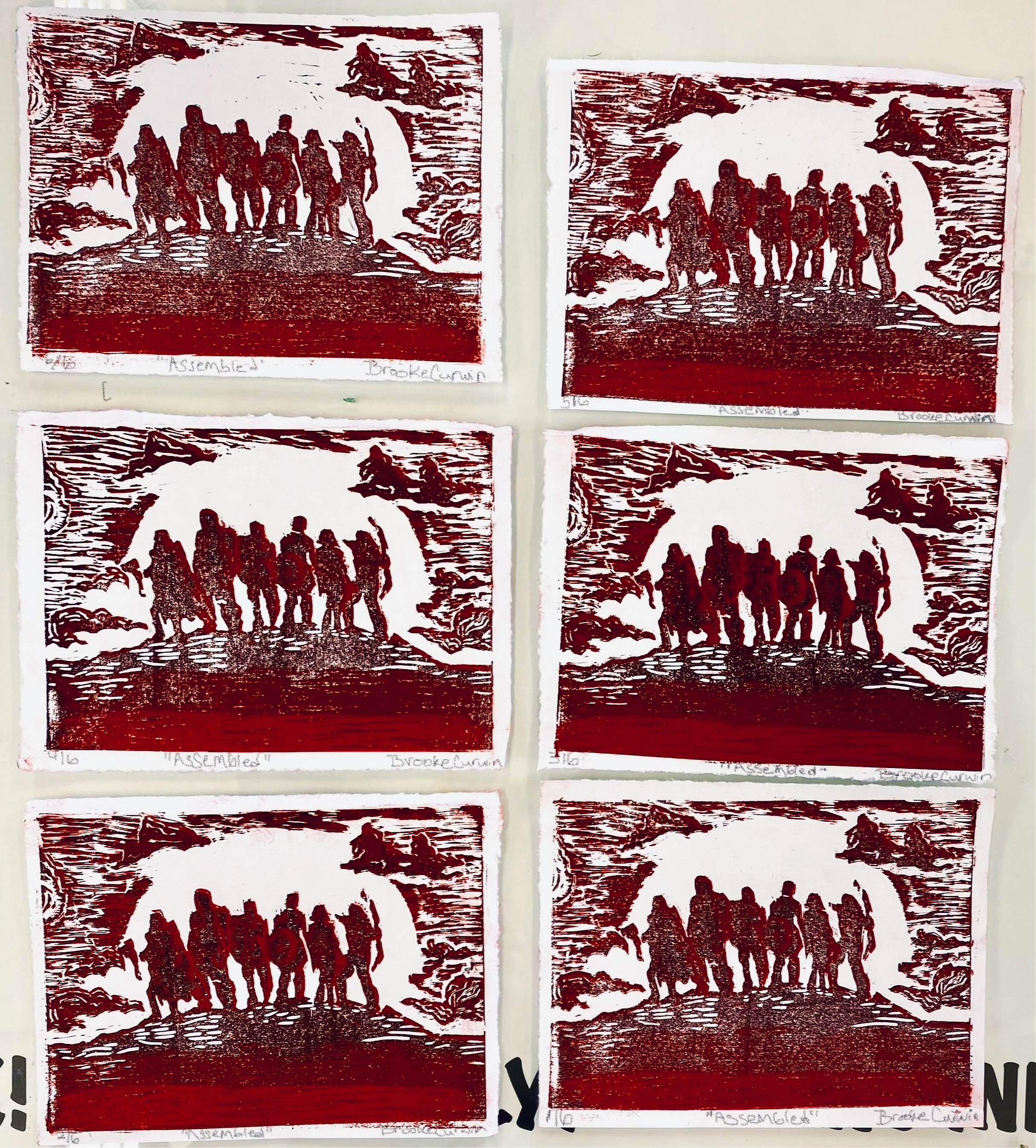 Six linocut prints of six figures on a hill at sunset