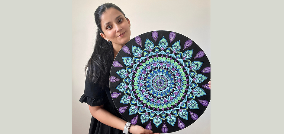 Surabhi holding a custom mandala creation