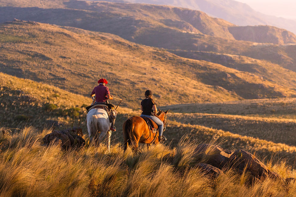 horseback riders on the grassy hills of cordoba in argentina