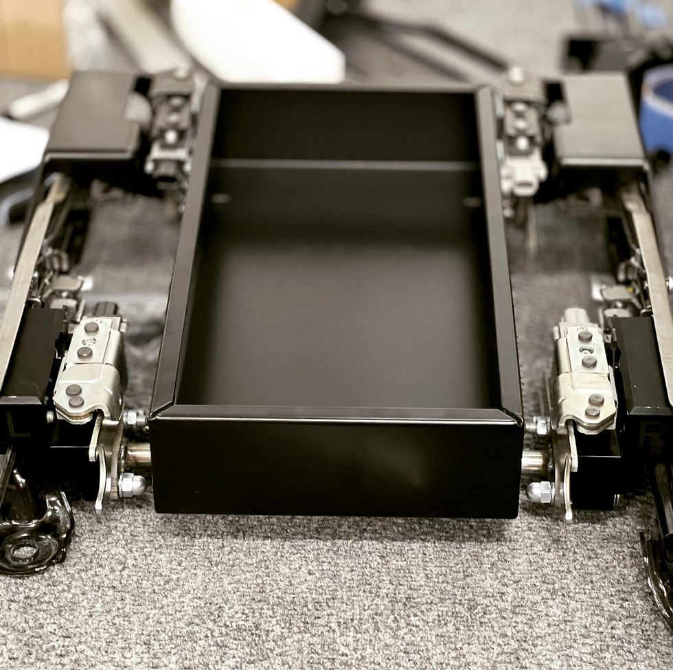 Passenger side non-Klima storage box wedged in between the load-cell array.