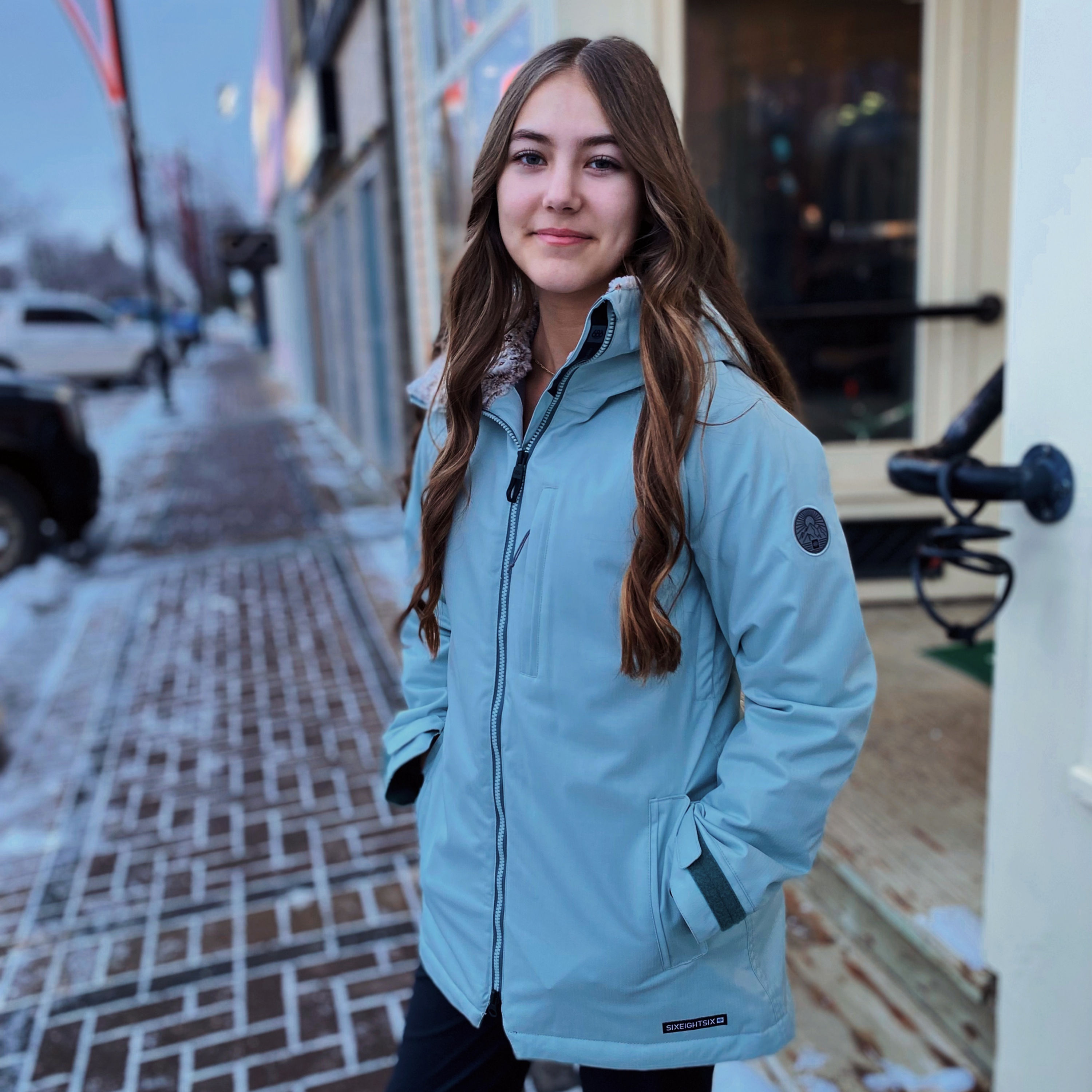 Women wearing 686 Dream Insulated Jacket color light blue. Front view