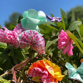 Thank you to everyone who celebrated the 25th Anniversary Weekend with us in the Walled Garden!

Until 22nd June, the Sunbury Embroidery Gallery is inviting the community to take part in a hands-on project marking the 25th Anniversary of the Millennium Embroidery. A dedicated patch in the Walled Garden is gradually being transformed into a colourful display of handmade textile flowers created by members of the public. 

Whether you are an experienced stitcher or entirely new to the craft, there is something for everyone. Visitors can choose from three simple flower designs, including one that requires no stitching at all. All materials are provided and support is available, making it an inclusive activity for all ages and abilities. 

Participation is free and no booking is required. The project has been made possible thanks to the generous support of Councillor Buddhi Weerasinghe and the Your Councillor Community Fund. 
Our aim is to see at least 330 flowers planted in the Walled Garden by 22nd June!​