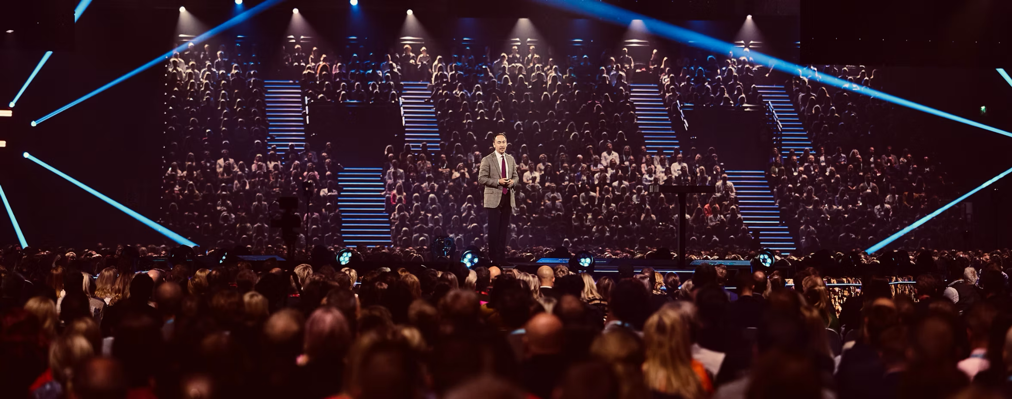 Michael Beckley delivering a keynote to a large audience