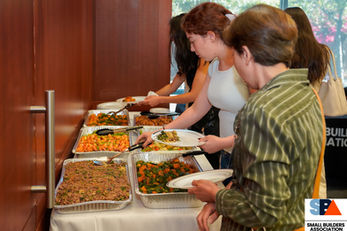 Small Builders Association event attendees networking and discussing industry topics