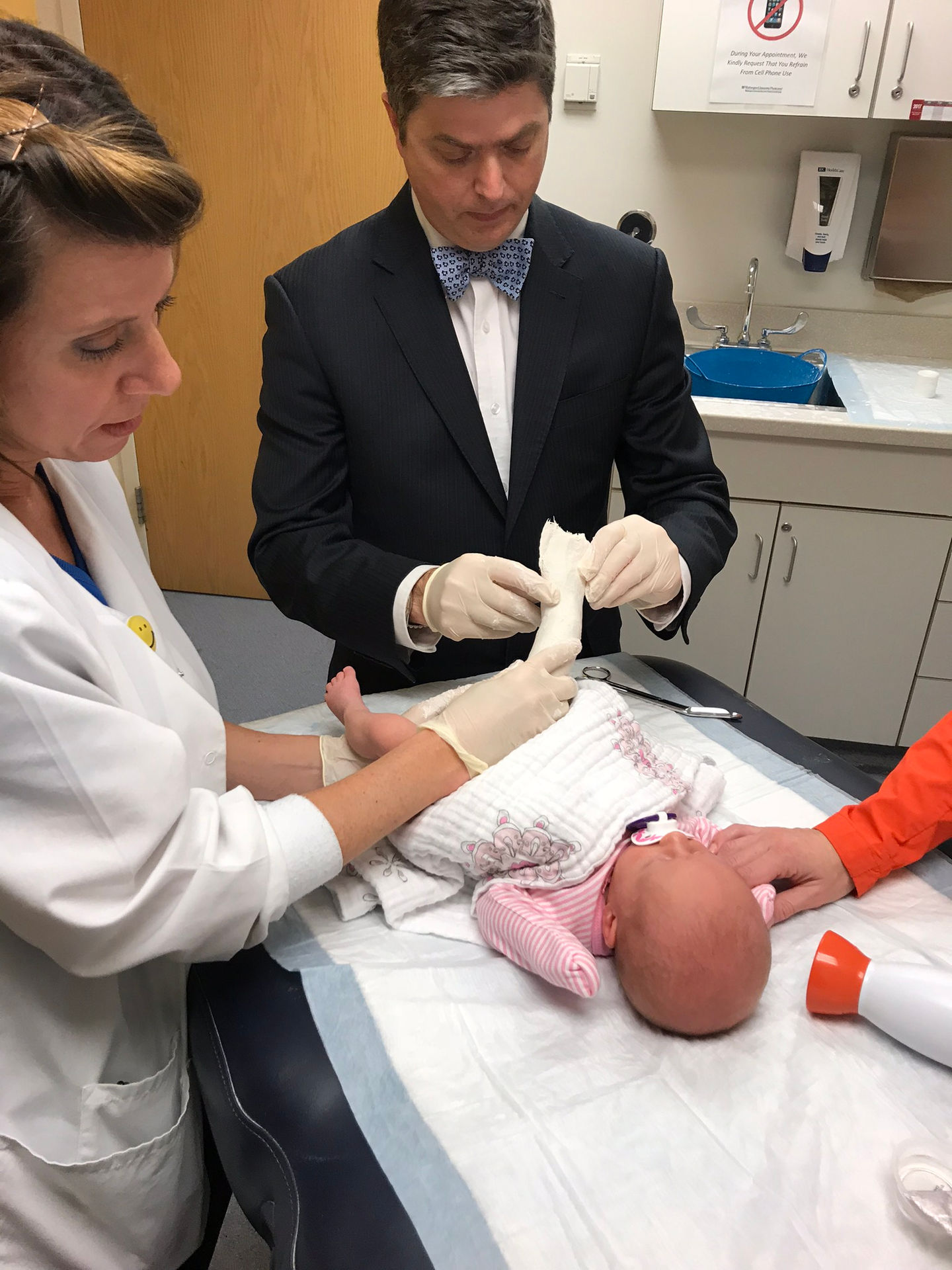 Dr. Dobbs applying plaster cast for clubfoot treatment