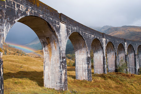 Glenfinnan in Scotland beautiful photo with rainbow by Geoff Wayman