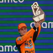 F1 driver holding trophy on podium