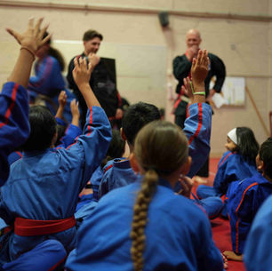 Children ages 6-12 years focus on a lesson being taught by their karate instructor