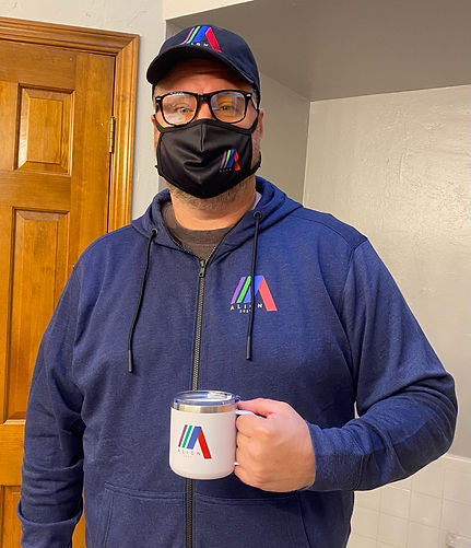An attendee wearing ALL the branded swag: hoodie, hat, glasses, and even the mug!