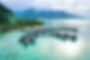 A luxury ocean cruise ship in the background in Tahiti. Luxury cruise travel agent in Arlington Virginia.