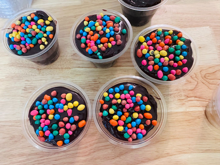 Close-up of freshly baked Cosmic Brownies topped with colorful chocolate candy chips.