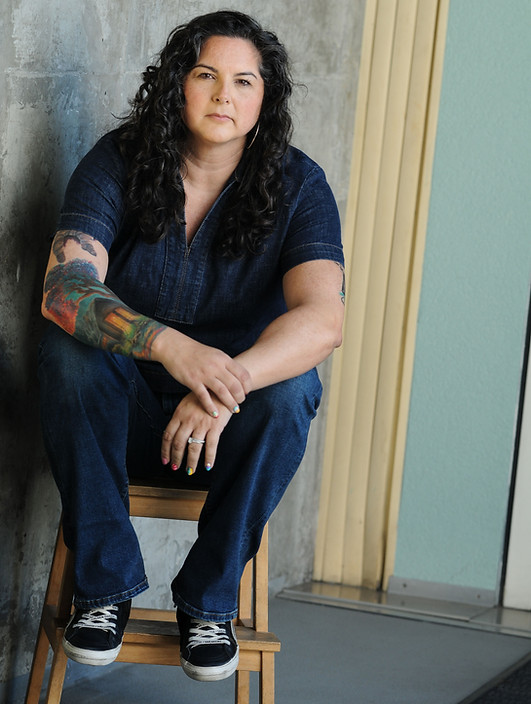 Dr. Sara Rice Schiff, Ph.D., clinical neuropsychologist in Northern California, seated casually with tattoo visible.