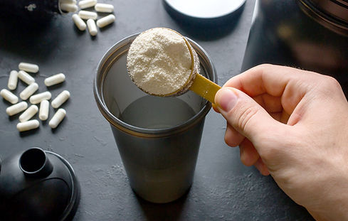 Powder-Protein-Supplement-In-A-Scooper-With-Dietary-Supplement-Pills.jpg