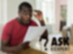Photo of a man looking shocked when reading his energy bill.