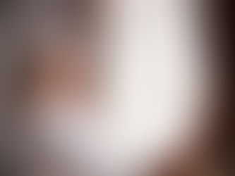 Photo of a smiling woman opening window curtains.