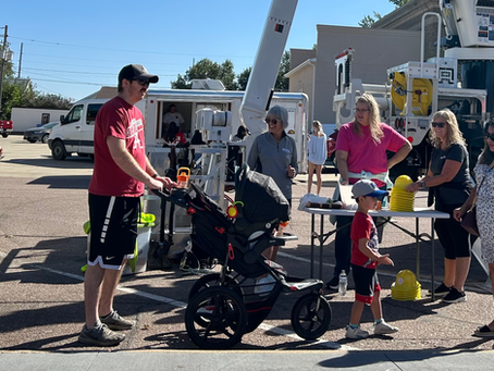 A family gathers around a utility truck.