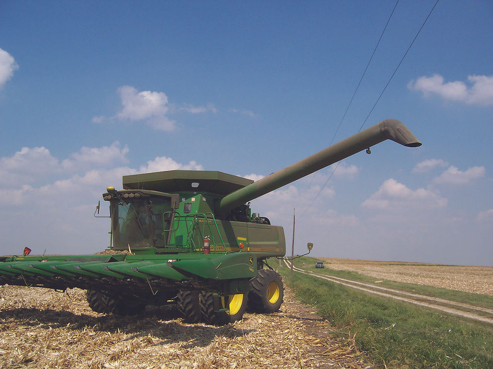 Photo of a green combine near powerlines