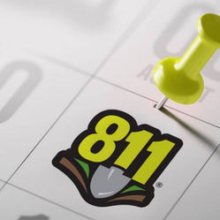 Close-up image of an August Calendar with an 811 logo with a shovel on it with a push-pin marking August 11.