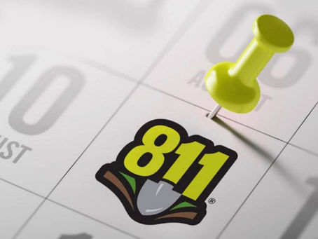 Close-up image of an August Calendar with an 811 logo with a shovel on it with a push-pin marking August 11.