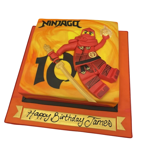Bespoke Ninjago Lego-themed cake with colorful edible bricks and character toppers, crafted in Solihull, West Midlands.