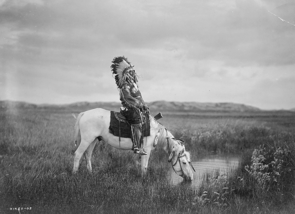 Red Hawk of the Oglala Lakota. Chief riding his horse.