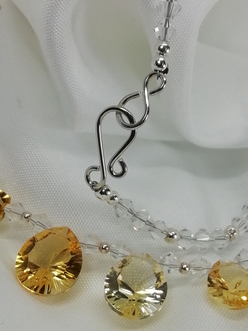 Thumbnail: Handmade Faceted pear-cut graduated citrines set on a swarovski crystal necklace