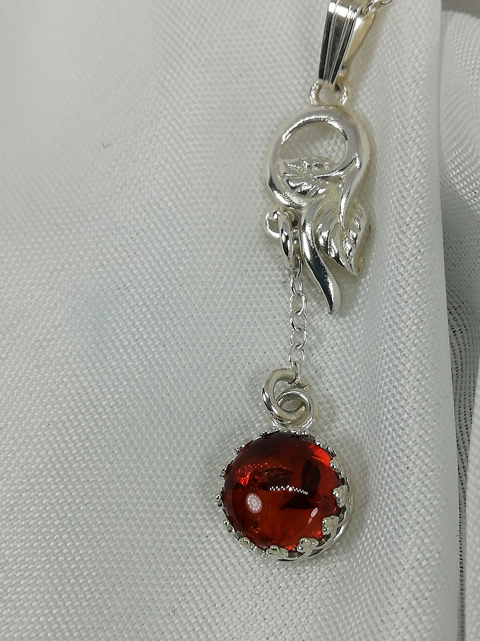 Handmade Sterling silver vine leaf set with an amber cabochon in galleried silver pendant