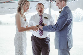 A bride and groom exchanging rings during a wedding ceremony