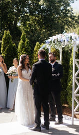 Bride and groom standing at the alter with officiant during the wedding ceremony.