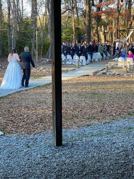 A bride and her dad walking down the aisle during a wedding ceremony