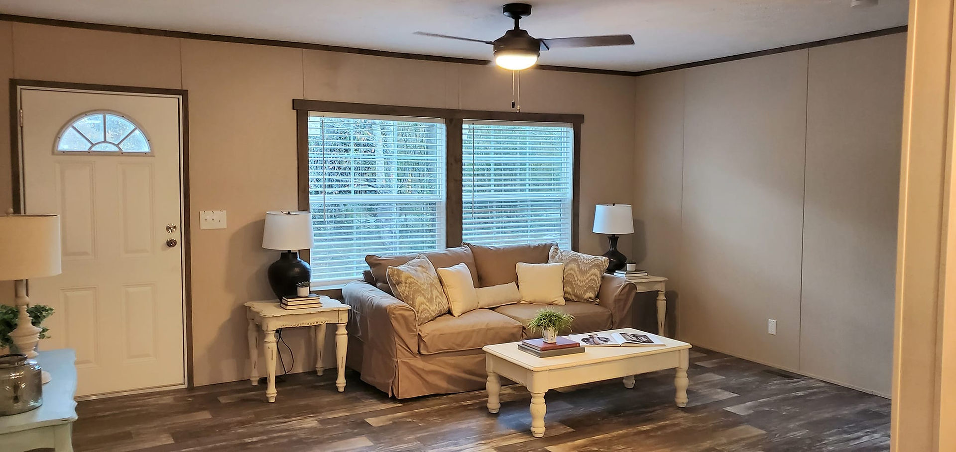 Another view of the living area with the couch, two end tables and a coffee table.