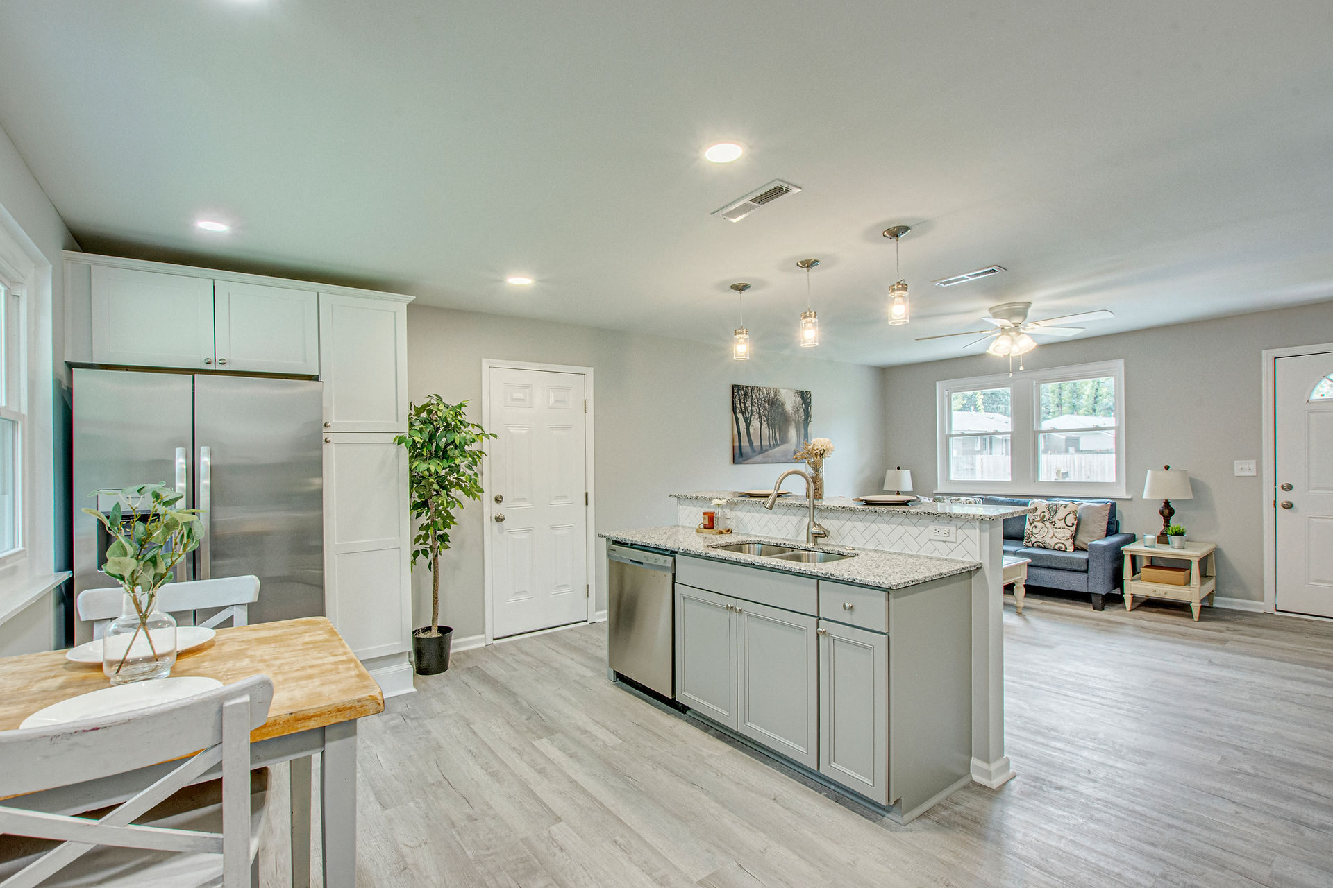 Another view of the open concept space shows the kitchen, dining and living areas.