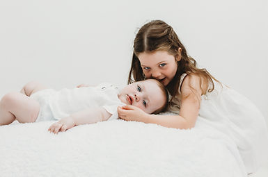 girl kissing baby boy